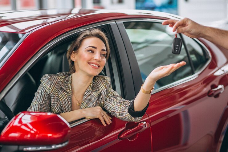 woman-sitting-red-car-receiving-keys_1303-14094